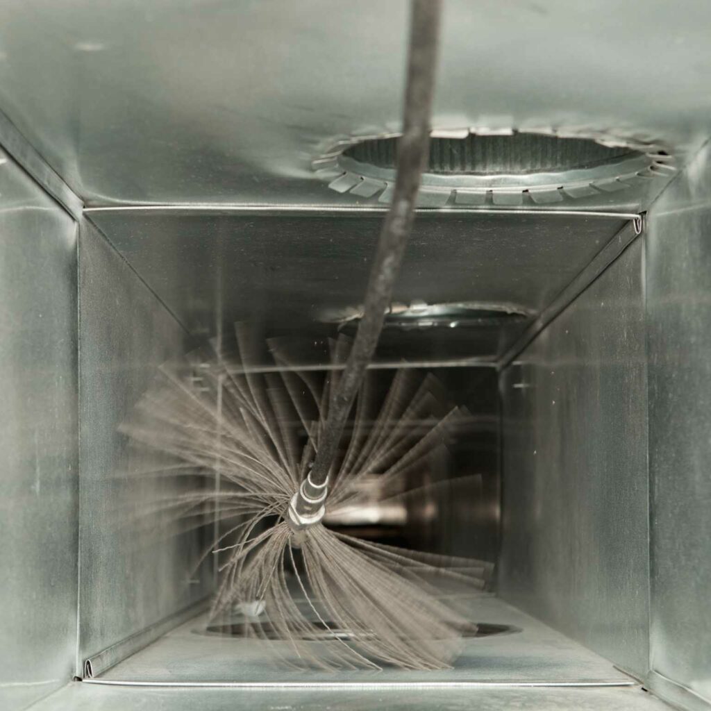 Point of view image showcasing a duct cleaning tool operate within an air duct.